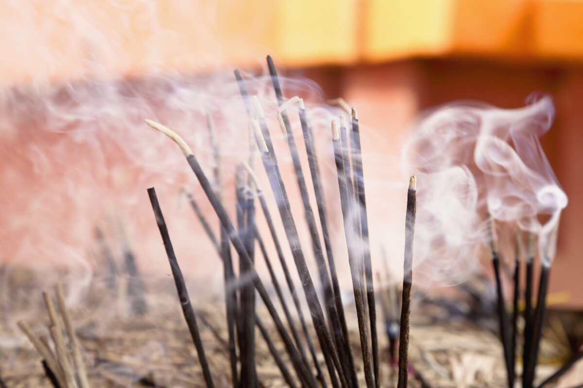 Incense sticks with rising smoke